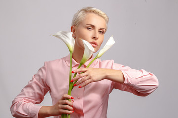 portrait of a young beautiful blonde girl with gentle decorative flowers