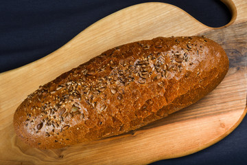 Many mixed breads and rolls shot from above. Top view of assortment of different cereal bakery