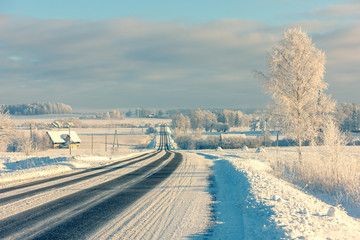 Road through the snowy hills of Latvia