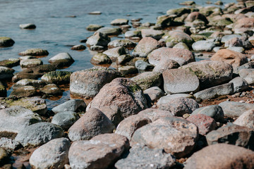 Ocean shore, sand and rocks on the sea coast.