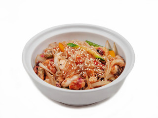 Funchosa with vegetables and seafood in a bowl on a white background