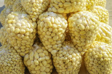 Raw potatoes in plastic bag