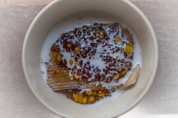 A blurry abstract background of a healthy dessert menu (sago from natural trees), bring to heat and add coconut milk, corn together, moderately sweet taste