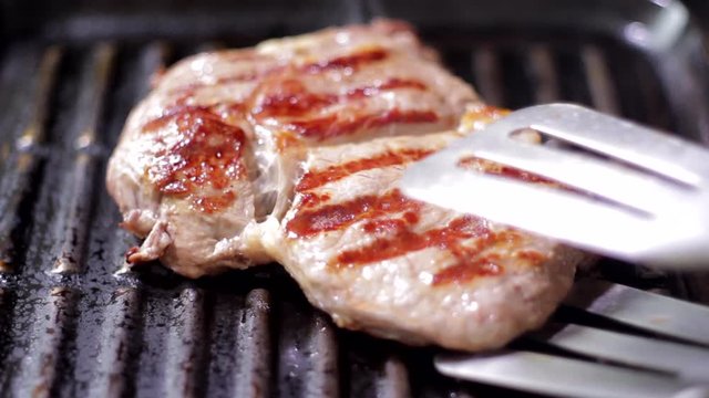 Grilling beaf steak. Cooking  meat. Delicious food preparation.