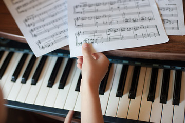 Close-up of a child's hand playing the piano . Favorite classical music. musical instruments for teaching music at home. The concept of a musical instrument. Self-education