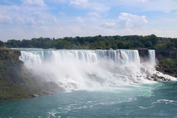 Obraz na płótnie Canvas Stunning view of Niagara Falls with blue sky background in Ontario, Canada
