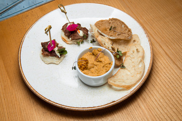 Fresh pate served with slices of bread.