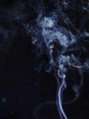 White cigarette smoke on a black background