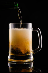 Beer with foam on black background