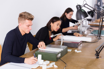 Obraz premium Student using scroll saw in architectural modeling