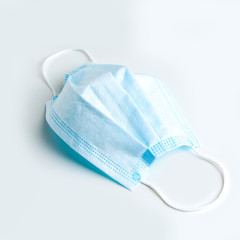 A medical mask on a white table.