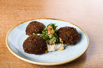 Falafel is a deep-fried ball, or a flat or doughnut-shaped patty, made from ground chickpeas