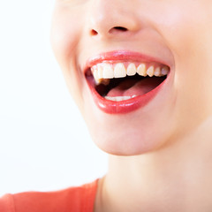 Laughing woman, female mouth with great teeth over white background. Healthy beautiful smile. Teeth health, whitening, prosthetics and care.