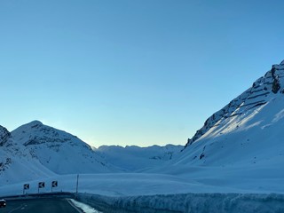 Sankt Moritz (Schweiz) wunderschöne Berglandschaft mit Schnee und Bäumen im Winter bei Blauem Himmel in der Natur mit Felsen mit Sicht auf den Gipfel beim Skifahren mit Passstraße 
