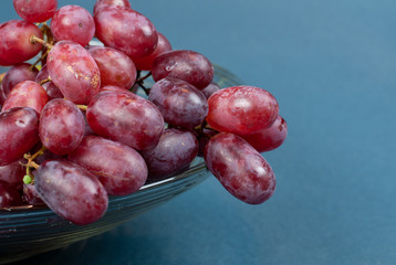purple table grapes in a glass bowl