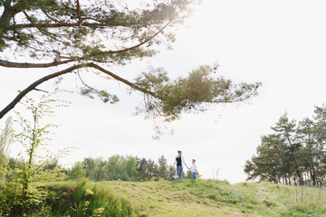 Stilish mother and handsome son having fun on the nature. Happy family concept. Beauty nature scene with family outdoor lifestyle. Happy family resting together. Happiness in family life. Mothers day.