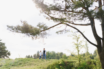 Happy young mother is playing with her baby in a park on a green lawn. Happiness and harmony of family life. Great family vacation. Good weekend. Mothers Day. Holiday. The concept of a happy family