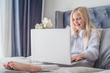 Pre teen girl playing on tablet. Virtual class lesson on video during self isolation at home. Distant remote video education. Modern school study for kids.
