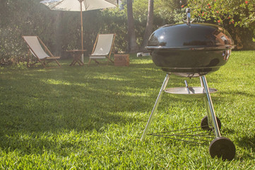 Summertime fun. Barbecue for summer family dinner in the backyard of the house.