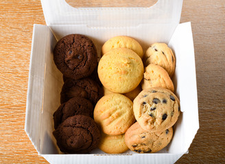 Homemade vanilla, orange, lemon chocolate chip cookies biscuits stack on a white plate