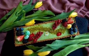 gluten-free dietetic cake with fresh wild berries. on a light silk background. with copy space. top view
