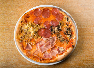 Pizza quattro stagioni is a variety of pizza in Italian cuisine that is prepared in four sections