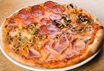 Pizza quattro stagioni is a variety of pizza in Italian cuisine that is prepared in four sections