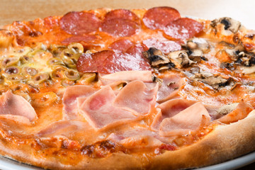 Pizza quattro stagioni is a variety of pizza in Italian cuisine that is prepared in four sections