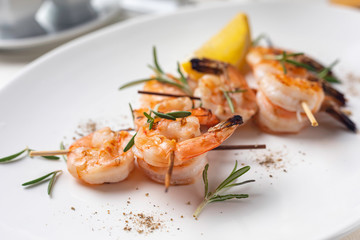 grilled shrimp on a white plate in a restaurant
