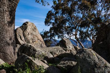 Bunch of rocks overlooking the valley of a mountain. Pile of rocks randomly placed on top of a hill