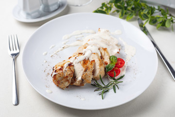 Grilled meat on a white plate in a served restaurant