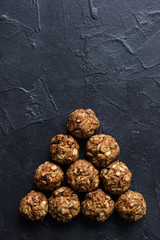 Healthy snack. Homemade oatmeal cookies with sunflower seeds on black background copy space