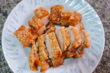 traditional Thai culture air fryer fried pork cuisine style or moo tod krob favorite famous street fast foods menu at thailand homemade
with hot spicy sauces on table wood dish sticky rice vegetable