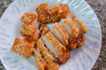 traditional Thai culture air fryer fried pork cuisine style or moo tod krob favorite famous street fast foods menu at thailand homemade
with hot spicy sauces on table wood dish sticky rice vegetable