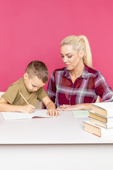 Tutor with child doing homework together in the pink room