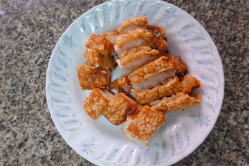 traditional Thai culture air fryer fried pork cuisine style or moo tod krob favorite famous street fast foods menu at thailand homemade
with hot spicy sauces on table wood dish sticky rice vegetable