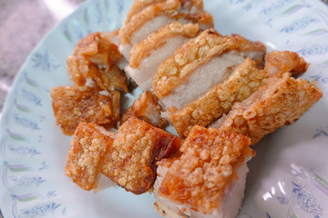 traditional Thai culture air fryer fried pork cuisine style or moo tod krob favorite famous street fast foods menu at thailand homemade
with hot spicy sauces on table wood dish sticky rice vegetable