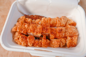 traditional Thai culture air fryer fried pork cuisine style or moo tod krob favorite famous street fast foods menu at thailand homemade
with hot spicy sauces on table wood dish sticky rice vegetable