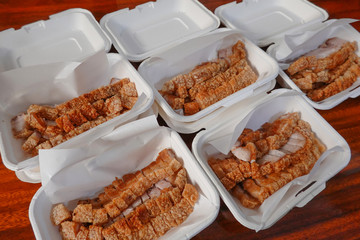 traditional Thai culture air fryer fried pork cuisine style or moo tod krob favorite famous street fast foods menu at thailand homemade
with hot spicy sauces on table wood dish sticky rice vegetable