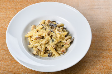 Traditional authentic italian penne al pollo e funghi pasta with mushroom ,chicken, parmesan cheese.