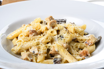 Traditional authentic italian penne al pollo e funghi pasta with mushroom ,chicken, parmesan cheese.