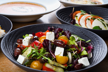 Greek salad or horiatiki salad is a salad in Greek cuisine. Greek salad is made with tomatoes