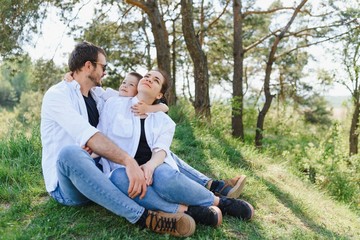 parents and child on vacation playing together outdoor