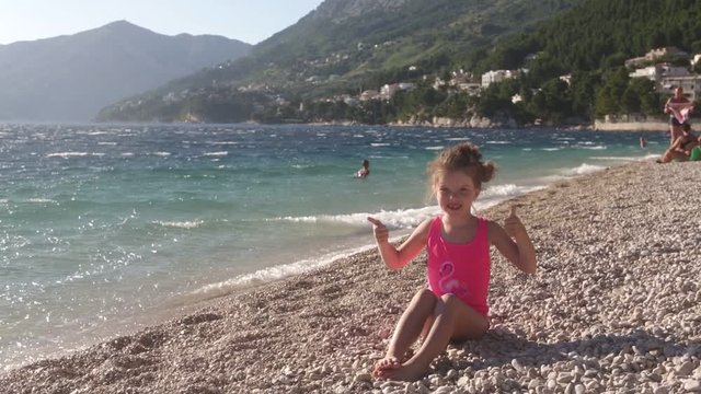 little girl plays on the beach in Croatia
