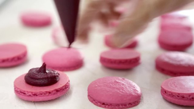 Process of making macaron macaroon, french dessert, squeezing the dough form cooking bag