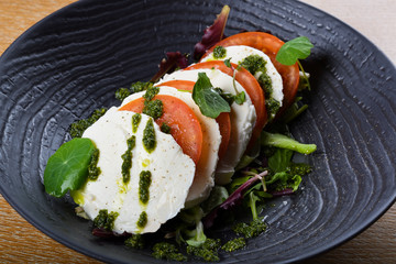 Caprese salad is a simple Italian salad, made of sliced fresh mozzarella, tomatoes,Insalata Caprese