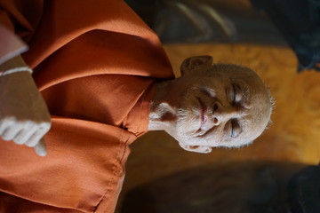 Realistic portrait, sculpture of the Dalai Lama in the temple