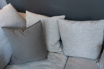 Modern gray fabric pillows on gray cloth sofa interior in living room decoration design building