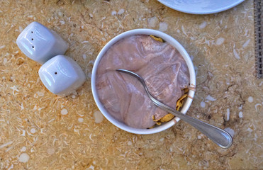 Stracciatella yogurt in small bowl with white spoon