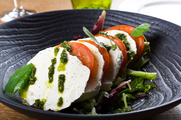 Caprese salad is a simple Italian salad, made of sliced fresh mozzarella, tomatoes,Insalata Caprese
